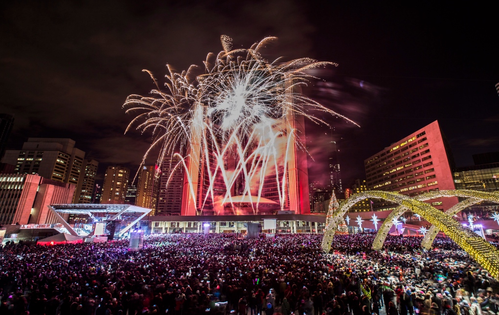 Fireworks explode during New Year's Eve celebrations at Nathan Phillips Square in Toronto early Wednesday, Jan. 1, 2014. (The Canadian Press/Mark Blinch)