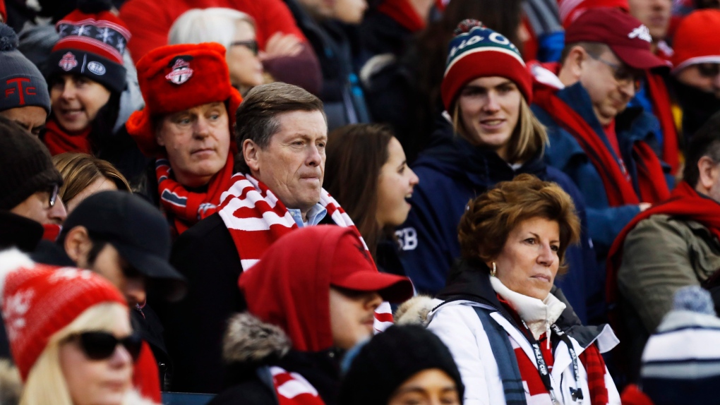 Toronto Mayor John Tory sits with fans as they wait for the start of MLS Cup Final soccer action between the Seattle Sounders and Toronto FC in Toronto on Saturday, December 9, 2017. THE CANADIAN PRESS/Mark Blinch 