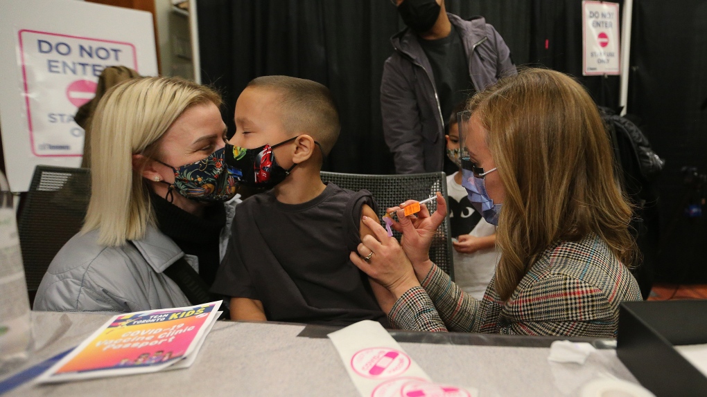 Children who are part of the Hospital for Sick Children family between the ages of 5 and 11 years of age are some of the first to get vaccinated for COVID-19 at the Metro Toronto Convention Centre, in Toronto, Tuesday, Nov. 23, 2021. THE CANADIAN PRESS/Steve Russell, POOL 