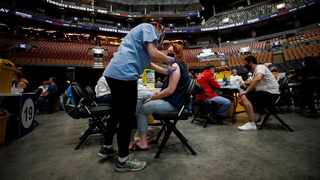 Shannon Bowler receives a COVID-19 vaccine at a mass vaccination clinic held inside Scotiabank Arena in Toronto on Sunday, June 27, 2021. THE CANADIAN PRESS/Cole Burston 