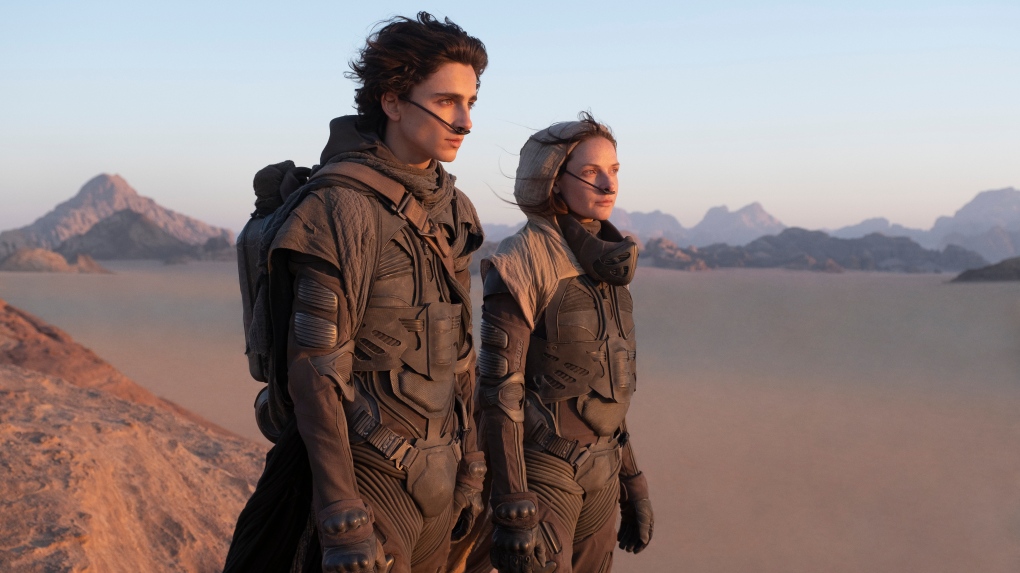 This image released by Warner Bros. Entertainment shows Timothee Chalamet, left, and Rebecca Ferguson in a scene from the upcoming 2021 film "Dune." Warner Bos. Pictures on Thursday announced that all of its 2021 film slate will stream on HBO Max at the same time they play in theaters. (Chia Bella James/Warner Bros. Entertainment via AP) 