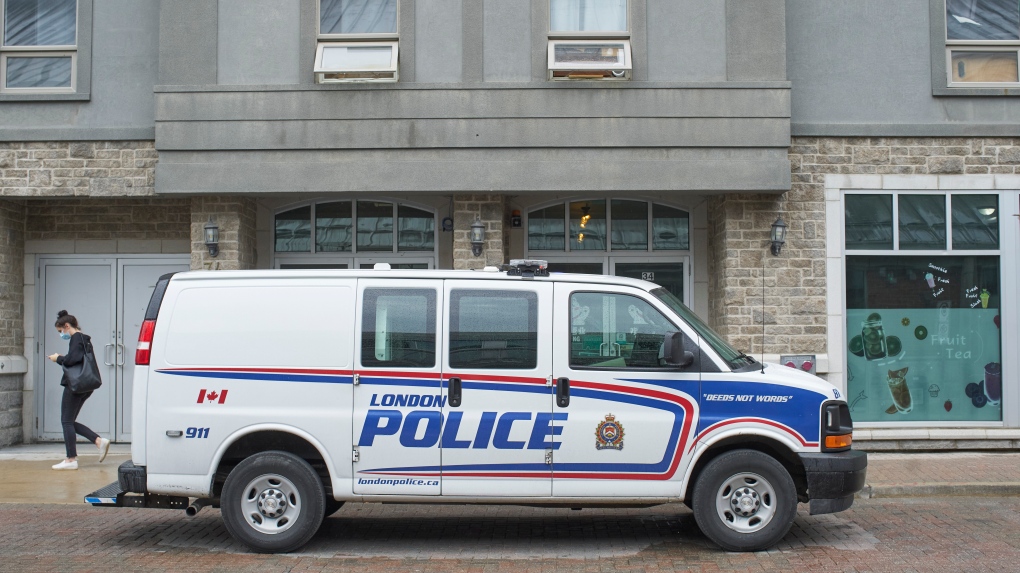 A police van sits outside of an address in London, Ont. on Tuesday, June 8, 2021. The address is linked to Nathaniel Veltman, the suspect in the murder of four members of a Muslim family on Sunday. THE CANADIAN PRESS/ Geoff Robins 