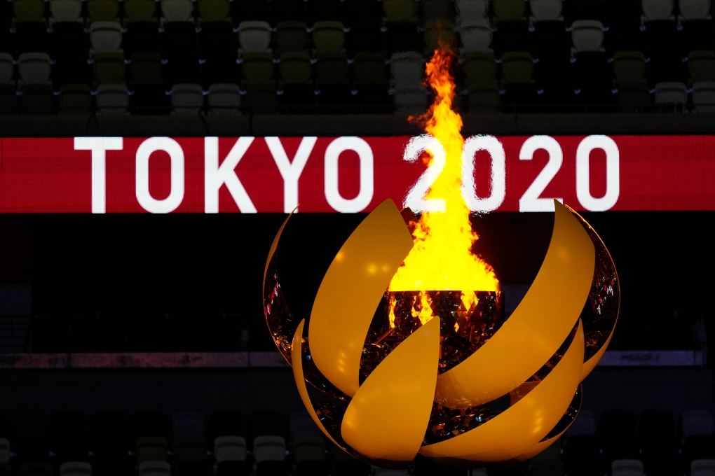 The Olympic flame burns during the opening ceremony in the Olympic Stadium at the 2020 Summer Olympics, Friday, July 23, 2021, in Tokyo, Japan. (AP Photo/Kirsty Wigglesworth)