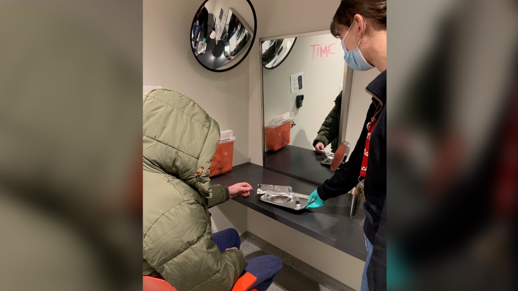 A photo of a client and a health care worker inside the newly opened drug inhalation booth at downtown Toronto's Casey House (Casey House photo)