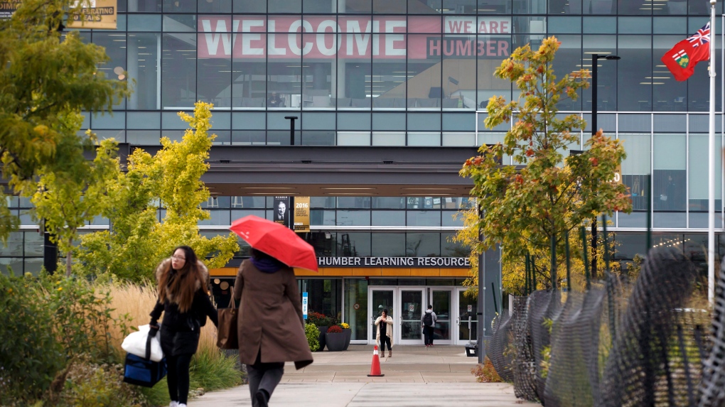 People walk around Humber College, in Toronto on Monday, October 16, 2017. THE CANADIAN PRESS/Cole Burston 