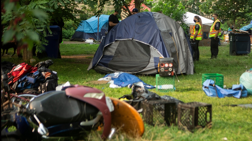 City officials work to clear the Alexandra Park encampment in Toronto on Tuesday, July 20, 2021. THE CANADIAN PRESS/Chris Young 