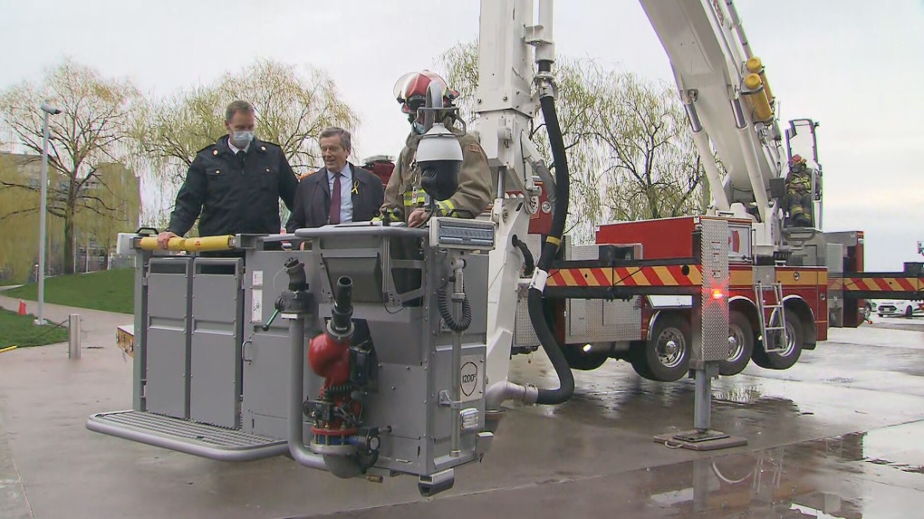 Mayor John Tory is seen on the city's new fire truck equipped with North America's tallest firefighting apparatus. 