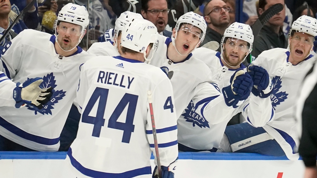 Toronto Maple Leafs defenseman Morgan Rielly (44) celebrates with the bench after his goal against the Tampa Bay Lightning during the first period in Game 3 of an NHL hockey first-round playoff series Friday, May 6, 2022, in Tampa, Fla. (AP Photo/Chris O'Meara)