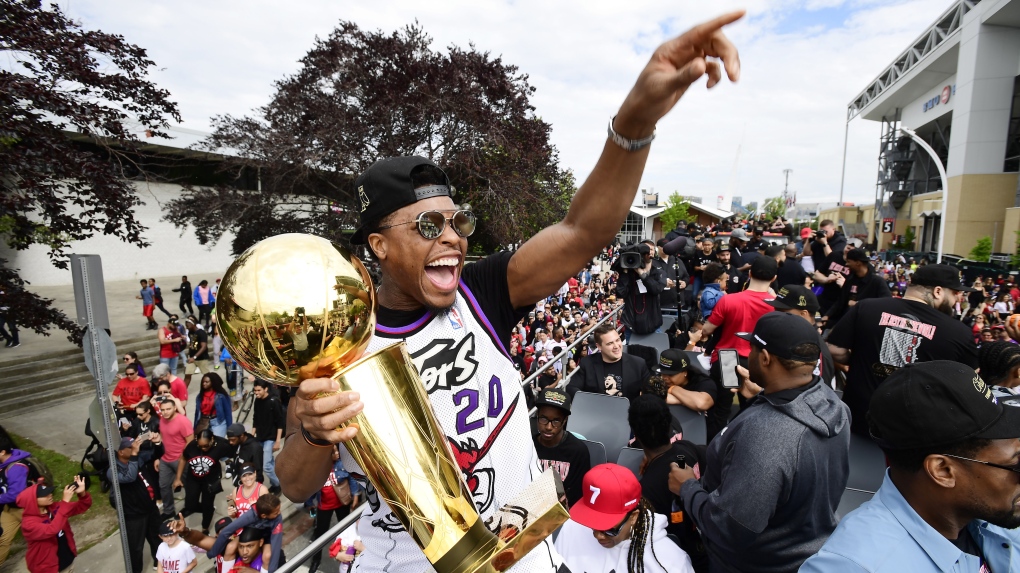 Toronto Raptors guard Kyle Lowry waves to fans holding the Larry O'Brien Championship Trophy during the 2019 Toronto Raptors Championship parade in Toronto on June 17, 2019. THE CANADIAN PRESS/Frank Gunn 