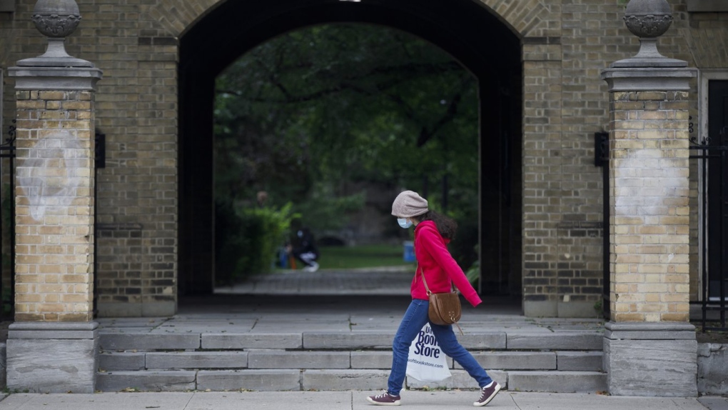 A woman walks on the University of Toronto campus in Toronto, Tuesday, Sept. 8, 2020. Experts say that a Toronto university's decision to require students and staff in student residences to have at least three doses of a COVID-19 vaccine will help boost third-dose uptake among young adults, but it will not have a significant effect unless other schools follow suit. THE CANADIAN PRESS/Cole Burston