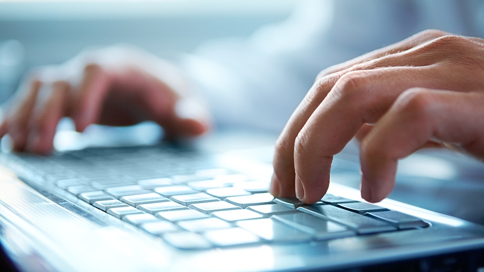 A person is seen typing. (Pressmaster/shutterstock.com)