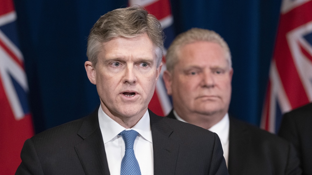 Ontario Premier Doug Ford listens as Finance Minister Rod Phillips speaks at a news conference at the Ontario Legislature in Toronto on Monday March 16, 2020. THE CANADIAN PRESS/Frank Gunn