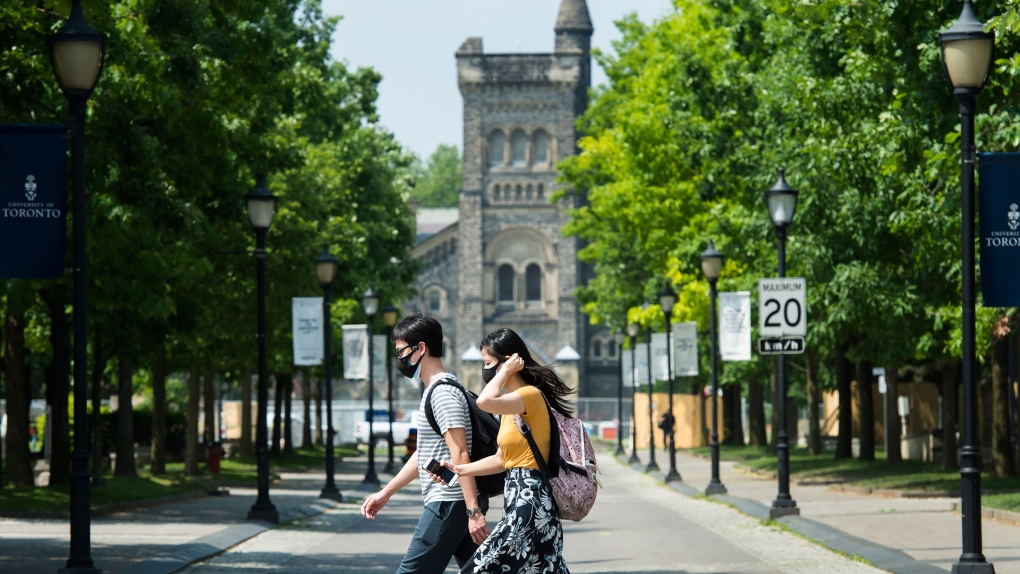 People walk past the University of Toronto campus during the COVID-19 pandemic in Toronto on Wednesday, June 10, 2020. The Ontario government announces the framework for reopening of colleges and universities as early as of July. THE CANADIAN PRESS/Nathan Denette