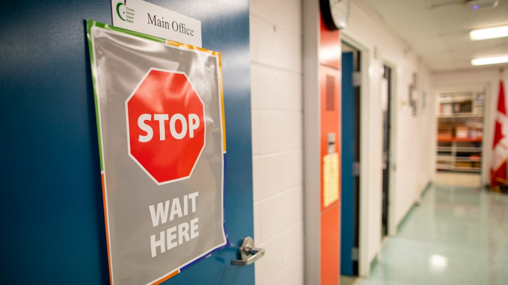A sign outside the main office is seen at Kensington Community School amidst the COVID-19 pandemic on Tuesday, September 1, 2020. THE CANADIAN PRESS/Carlos Osorio