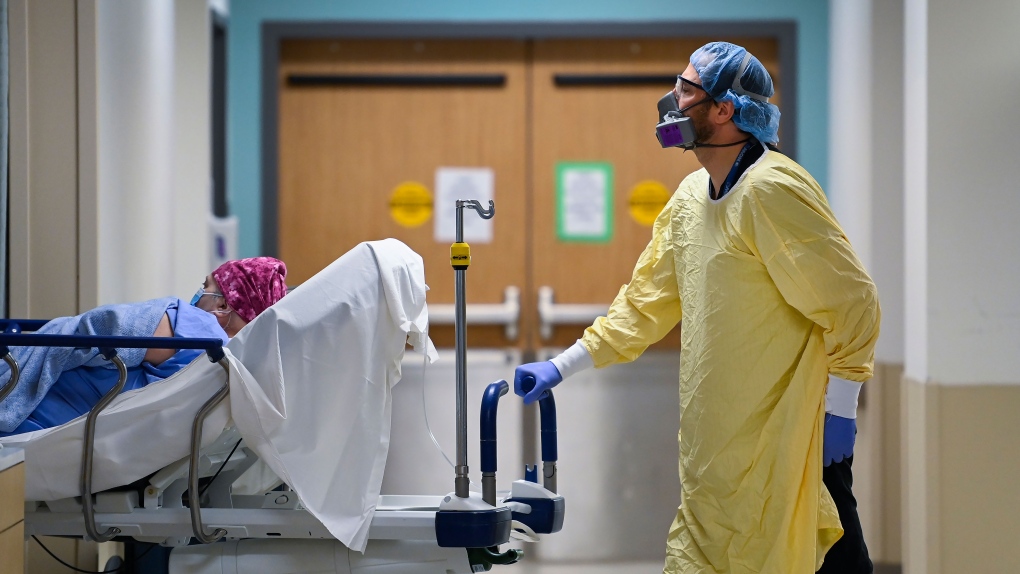 A health-care worker wearing PPE transports a patient in the dialysis unit at the Humber River Hospital during the COVID-19 pandemic in Toronto on Wednesday, December 9, 2020. THE CANADIAN PRESS/Nathan Denette