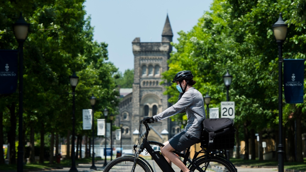 A person bicycles past the University of Toronto campus on Wednesday, June 10, 2020. (THE CANADIAN PRESS/Nathan Denette)
