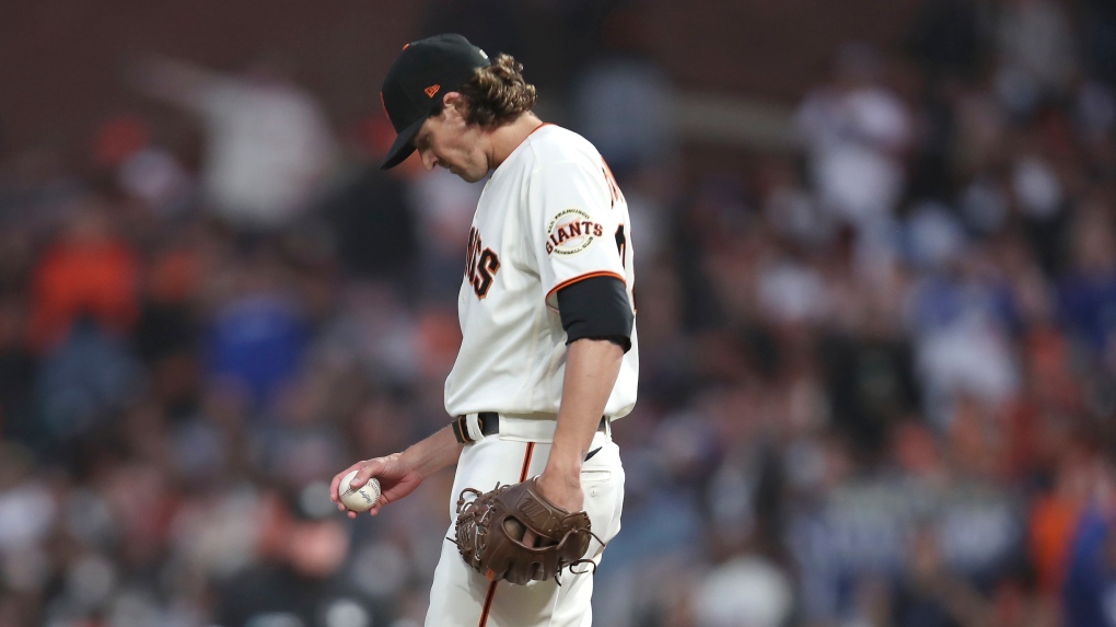 San Francisco Giants pitcher Kevin Gausman reacts on the mound during the second inning of Game 2 of a baseball National League Division Series against the Los Angeles Dodgers Saturday, Oct. 9, 2021, in San Francisco. (AP Photo/Jed Jacobsohn) 