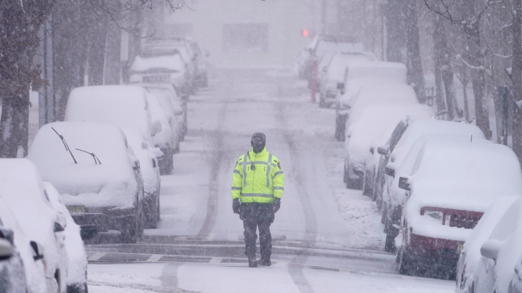 A traffic officer patrols a lightly trafficked street in Weehawken, N.J., Monday, Feb. 1, 2021. (AP Photo/Seth Wenig)