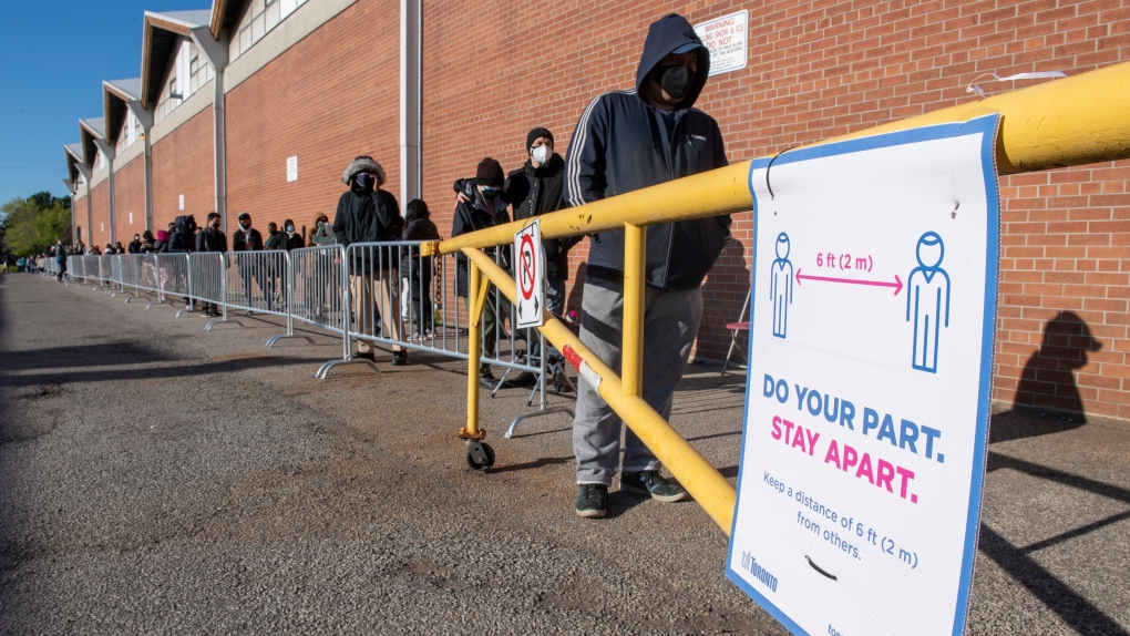 Young people line up for COVID-19 vaccines at Downsview Arena in Toronto on Monday, May 10, 2021. Ontario has just opened up vaccines for 18+ in high risk areas. THE CANADIAN PRESS/Frank Gunn