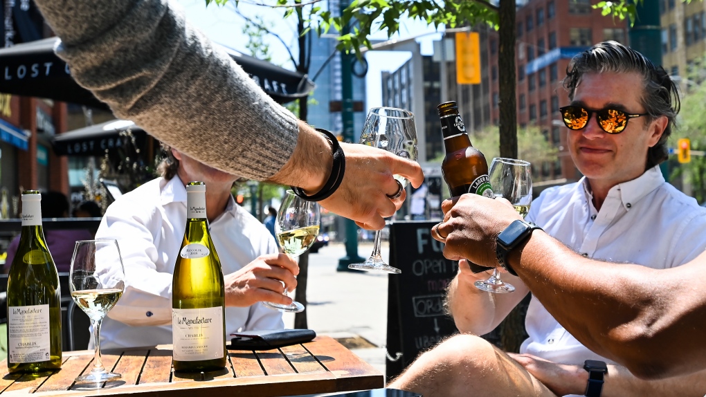 People enjoy drinks and friends on outdoor patios during the COVID-19 pandemic in downtown Toronto on Friday, June 11, 2021. THE CANADIAN PRESS/Nathan Denette 