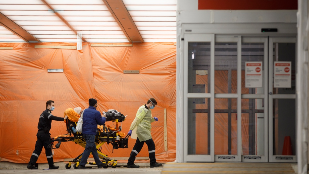 Paramedics wheel a patient into the emergency department at Mount Sinai Hospital in Toronto, Wednesday, Jan. 13, 2021. THE CANADIAN PRESS/Cole Burston 