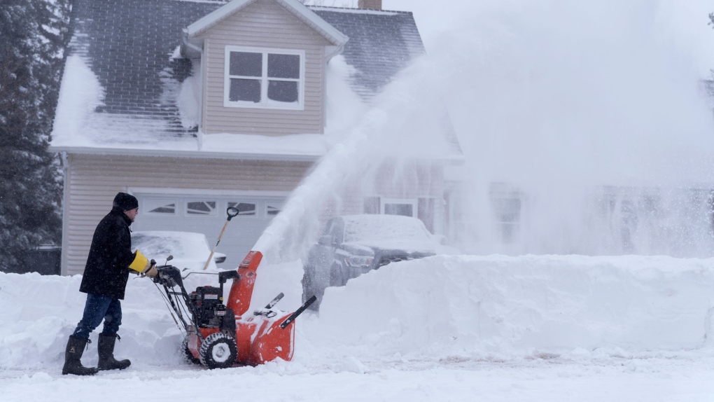 A man clears his driveway after a snowstorm on Saturday January 15, 2022. THE CANADIAN PRESS/John Morris 
