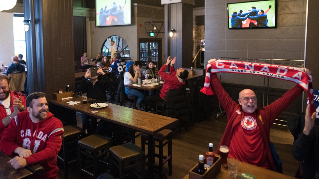 Fans react after Canadian Men’s National Team wins its FIFA CONCACAF World Cup Qualifying Match 4-0 against Jamaica, at Elephant and Castle in Toronto, on Sunday, March 27, 2022. THE CANADIAN PRESS/ Tijana Martin