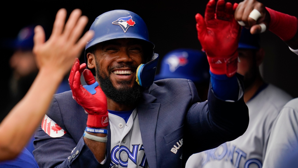 Toronto Blue Jays' Teoscar Hernandez is greeted in the dugout after hitting a solo home run against the Baltimore Orioles during the eighth inning of the first game of a baseball doubleheader, Monday, Sept. 5, 2022, in Baltimore. The Blue Jays won 7-3. (AP Photo/Julio Cortez)