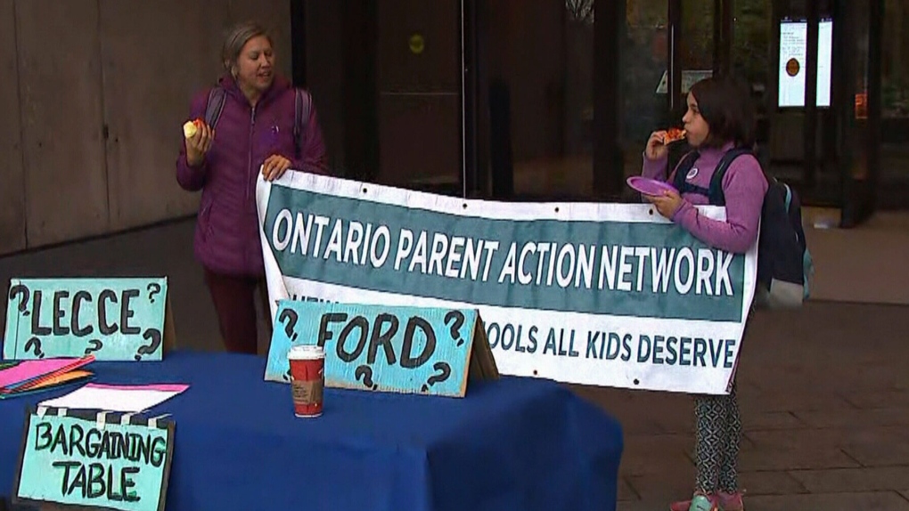 Parents and supporters of Ontario education support workers gathered in downtown Toronto for a rally against Ontario's anti-strike bill.