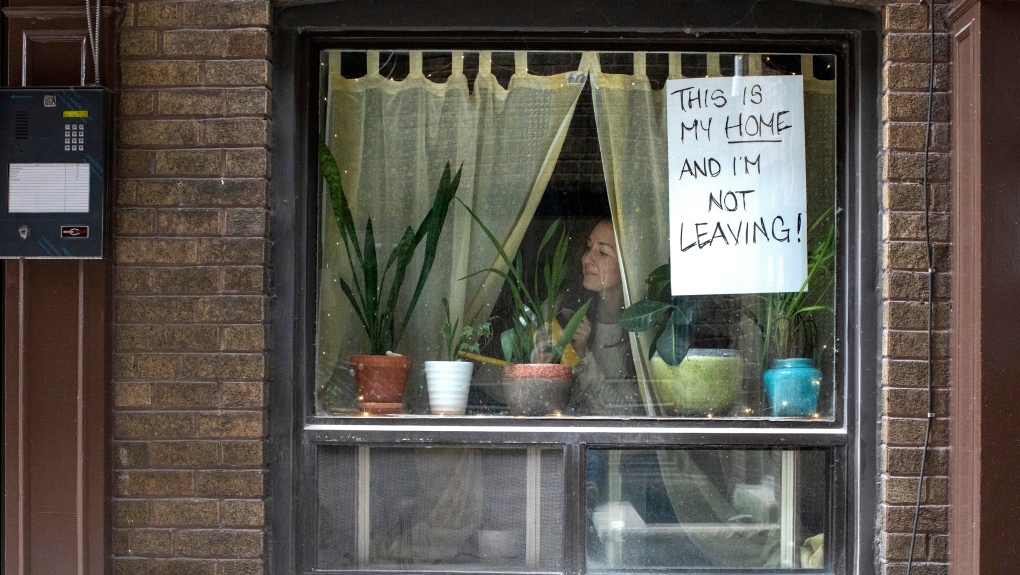 "Lee" is pictured at the window of her west Toronto apartment on Thursday March 19, 2020. THE CANADIAN PRESS/Chris Young