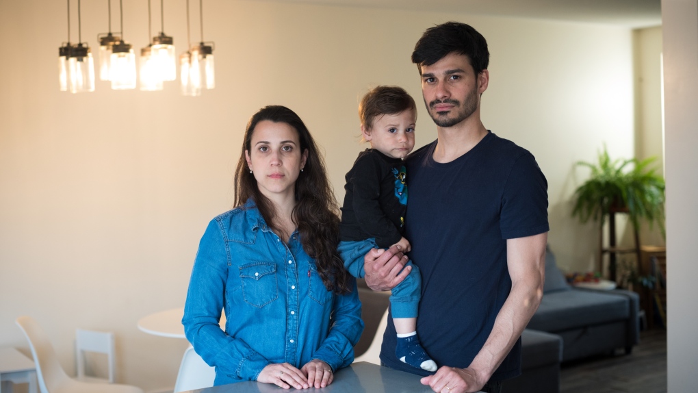 Graziela Cariello and Thiago Lang pose for a photograph with their 19-month-old son Pedro at their home in Barrie, Ont., on Monday, April 25, 2022. The family spent most weekends last year viewing places in the GTA, placed at least five bids, but the high prices and bidding wars drove the family all the way to Barrie. THE CANADIAN PRESS/Tijana Martin