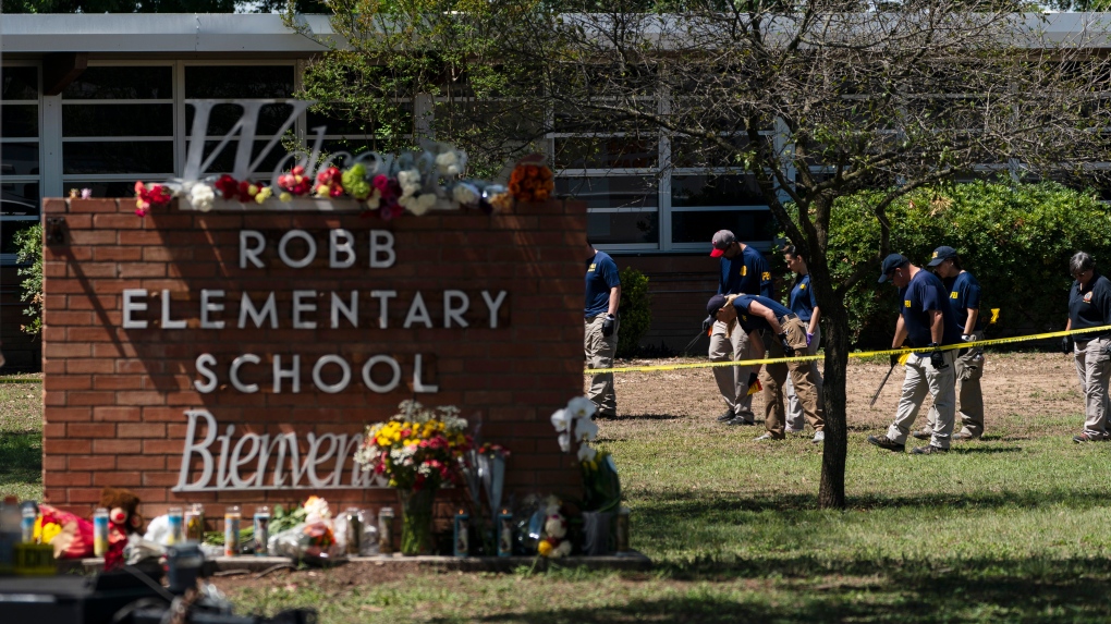 Investigators search for evidences outside Robb Elementary School in Uvalde, Texas, Wednesday, May 25, 2022. Desperation turned to heart-wrenching sorrow for families of grade schoolers killed after an 18-year-old gunman barricaded himself in their Texas classroom and began shooting, killing several fourth-graders and their teachers. (AP Photo/Jae C. Hong) 