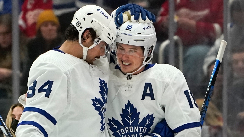 Toronto Maple Leafs right wing Mitch Marner (16) celebrates his third goal of the game with Auston Matthews (34) in the second period of an NHL hockey game against the Detroit Red Wings Saturday, Feb. 26, 2022, in Detroit.THE CANADIAN PRESS/AP/Paul Sancya