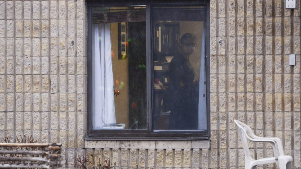 Ontario is proposing to increase fines to long-term care homes that do not have air conditioning in every room. A worker is shown through a window at a long-term care home in Almonte, Ont. on Thursday, April 9, 2020. THE CANADIAN PRESS/Sean Kilpatrick