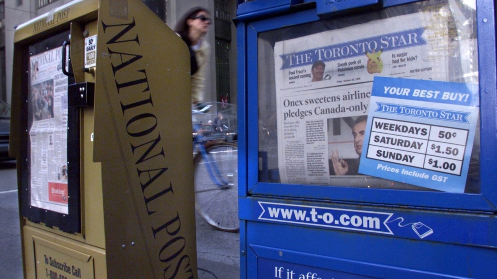One expert says talks between Canada's two largest newspaper chains about a potential merger are akin to a "Hail Mary pass" amid declining readership and advertising revenue. Toronto Star and National Post newspaper boxes are shown in downtown Toronto on Friday, October 29, 1999. THE CANADIAN PRESS/Kevin Frayer