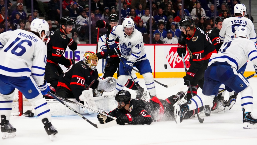 Ottawa Senators goaltender Joonas Korpisalo (70) keep his eye on the puck as his teammates fight for control against the Toronto Maple Leafs during the final minute of play in the third period NHL hockey action in Ottawa on Saturday, Feb. 10, 2024. THE CANADIAN PRESS/Sean Kilpatrick