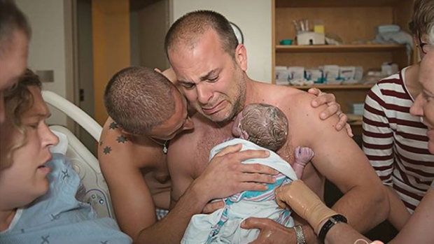 Photo of dads holding baby goes viral